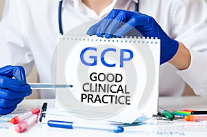 Doctor holding a card with text GCP, medical concept