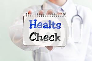 Doctor holding a card with text HEALTS Check medical concept