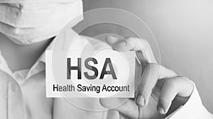 Doctor holding a card with text HSA Health Saving Account