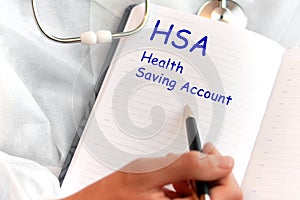 Doctor holding a card with text HSA, medical concept