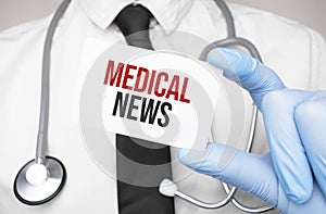 Doctor holding a card with text medcal news,medical concept