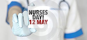 Doctor holding a card with text nurses day 12 may , medical concept