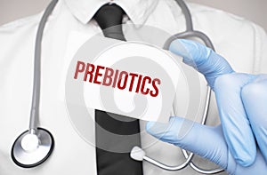 Doctor holding a card with text PREBIOTICS,medical concept photo