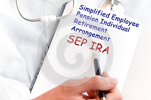 Doctor holding a card with text SEP IRA, medical concept