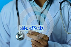 Doctor holding a card with text side effects. Medical and healthcare concept