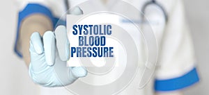 Doctor holding a card with text SYSTOLIC BLOOD PRESSURE, medical concept photo