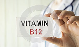 Doctor holding a card with Vitamin B12, Medical