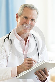 Doctor Holding Clipboard In Clinic