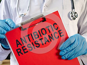 Doctor holding a clipboard with the inscription Antibiotic resistance.