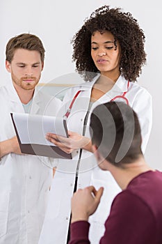 Doctor holding clipboard with patient medical record chart