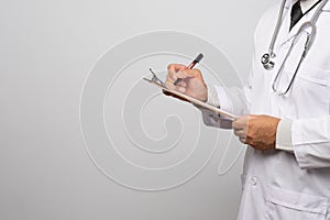 Doctor holding clipboard with sheet of paper. Doctor and stethoscope. Health care concept