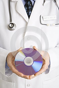 Doctor holding compact disc. photo