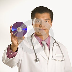 Doctor holding compact disc.