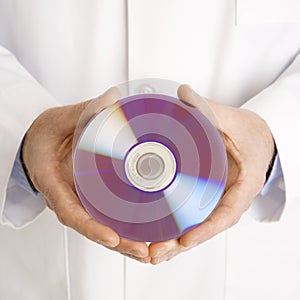 Doctor holding compact disc. photo