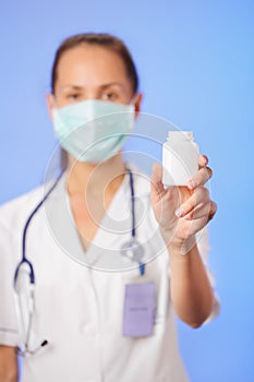 Doctor holding container with medicine