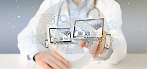 Doctor holding a Devices connected to a cloud multimedia network 3d rendering