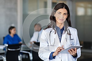 Doctor holding digital tablet at meeting room