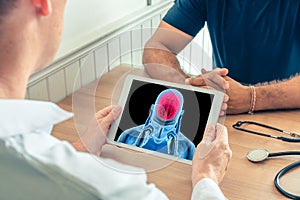 Doctor holding a digital tablet with x-ray of a brain of a patient. Brain cancer or headache prevention