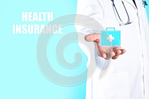 Doctor holding first aid kit icon against color background.