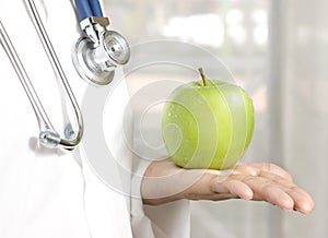 Doctor holding a green apple