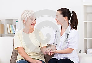 Doctor holding hand of patient