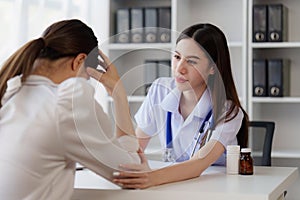 Doctor holding hand patient woman at clinic. health care, medical, healthy concept