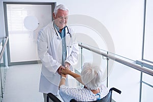 Doctor holding hands of senior patient