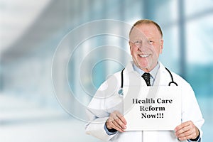 Doctor holding health care reform now sign standing in hospital photo
