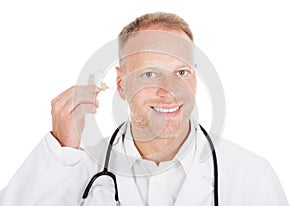 Doctor Holding Hearing Aid Device