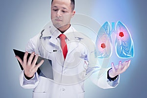 Doctor holding human organs and tablet on grey background . High resolution.