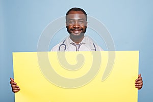 Doctor holding large yellow banner