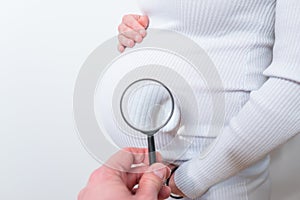 Doctor Holding Magnifying Glass Showing belly Care Concept