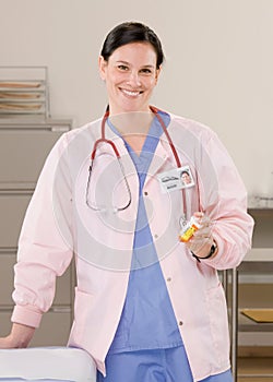 Doctor holding medication in examination roo