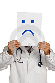 Doctor holding negative smiley face before