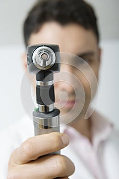 Doctor Holding Otoscope