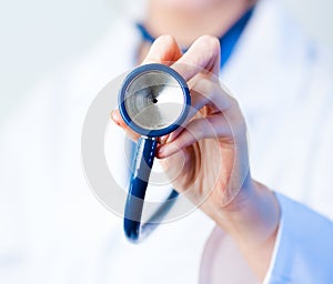 Doctor holding out stethescope photo