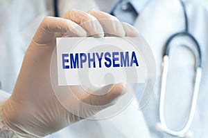 Doctor holding a paper card with text EMPHYSEMA, medical concept
