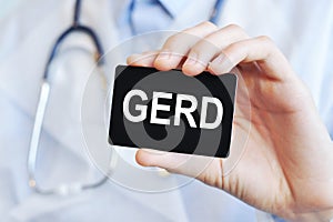 Doctor holding a paper card with text GERD, medical concept