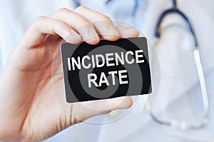 Doctor holding a paper card with text incidence rate, medical concept