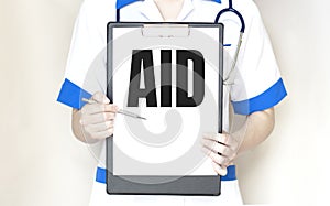 Doctor holding paper plate with text AID, medical concept