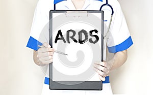 Doctor holding a paper plate with text ARDS, medical concept