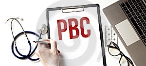 Doctor holding a paper plate with text PBC, medical concept