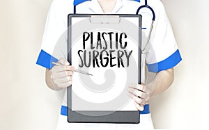 Doctor holding paper plate with text Plastic Surgery, Medical concept