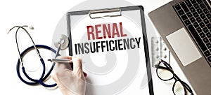 Doctor holding a paper plate with text RENAL INSUFFICIENCY, medical concept