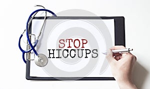 Doctor holding a paper plate with text STOP HICCUPS, medical concept photo