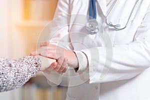 Doctor holding patient`s hand