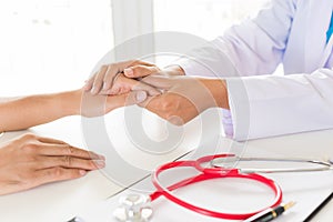 Doctor holding patient`s hand. Medicine and health care concept.
