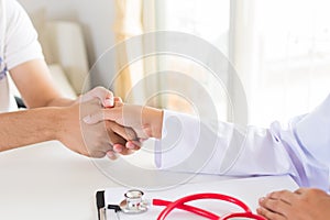 Doctor holding patient`s hand. Medicine and health care concept.