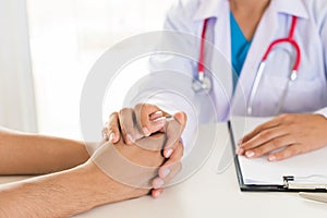 Doctor holding patient`s hand. Medicine and health care concept.