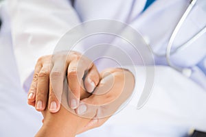 Doctor holding patient`s hand. Medicine and health care concept.